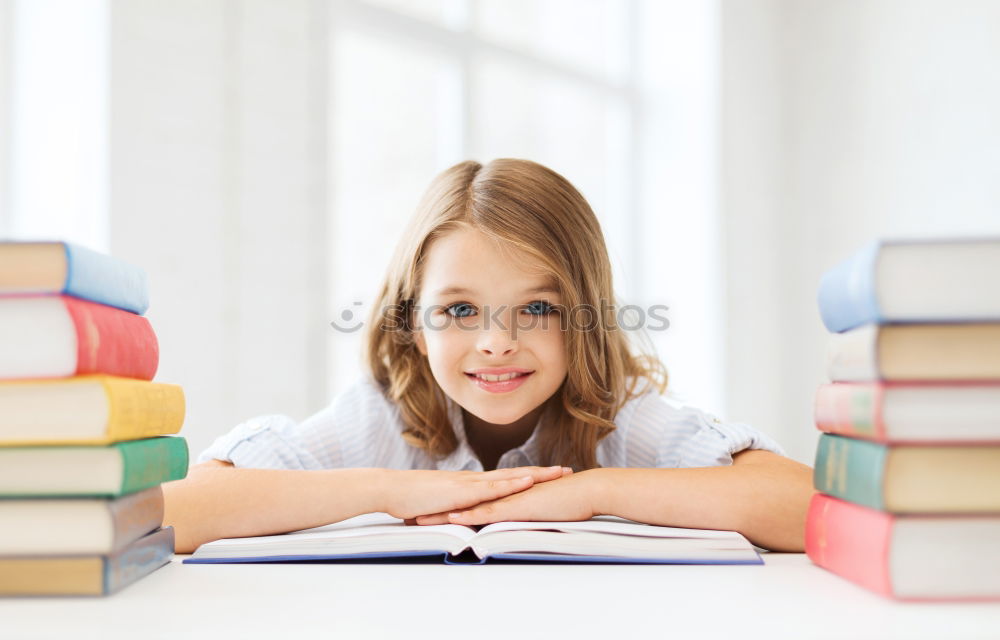 Similar – Schoolgirl reading a book in classroom