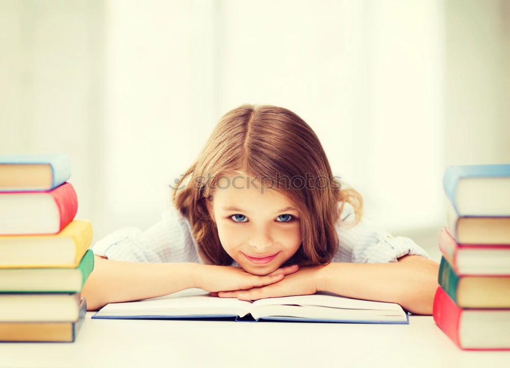 Similar – Schoolgirl reading a book in classroom