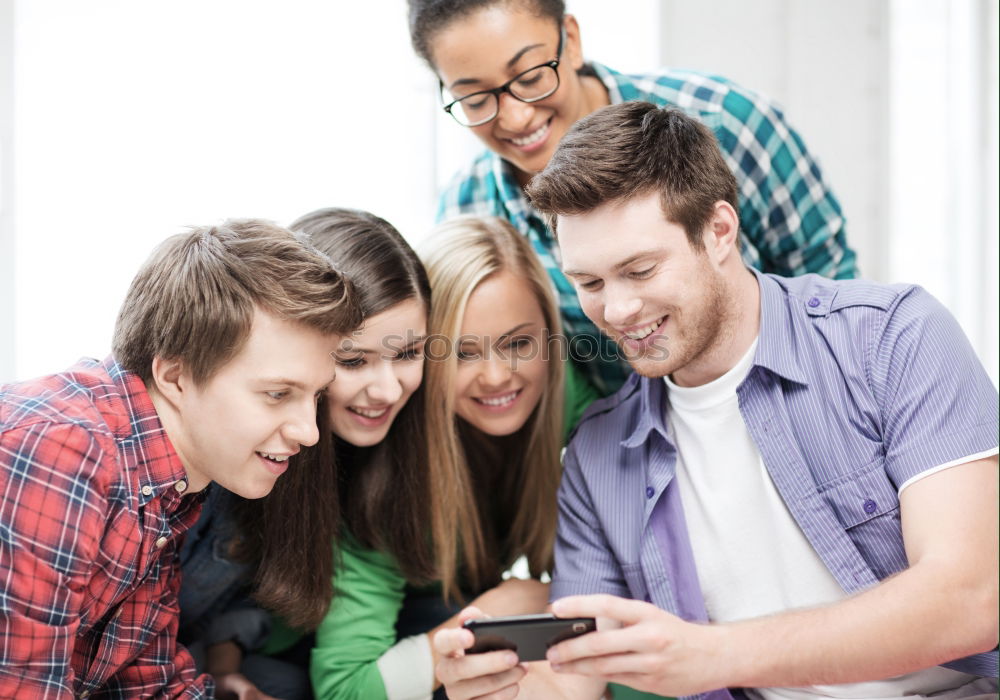 Similar – Multiracial group looking at a tablet computer outdoors