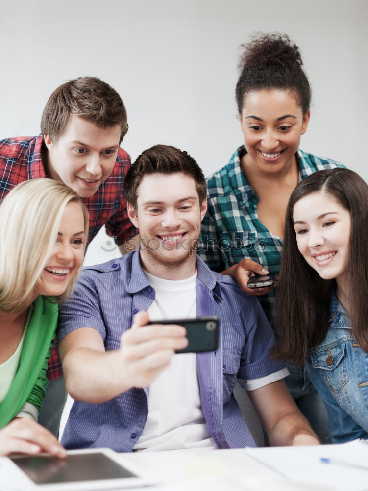 Similar – Image, Stock Photo Multiracial young people looking at a tablet computer