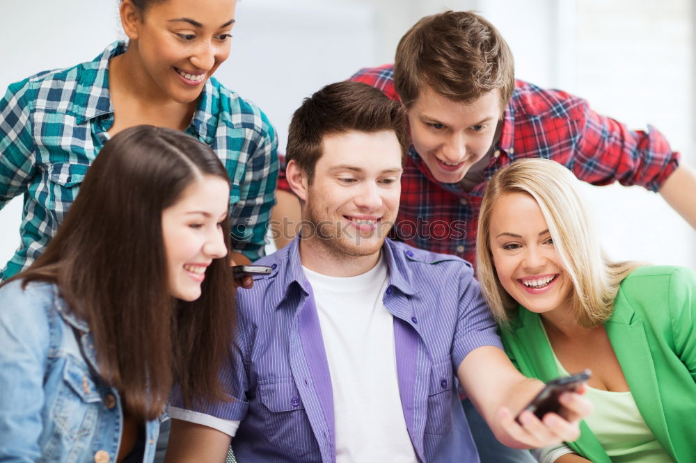 Similar – Multiracial group looking at a tablet computer outdoors