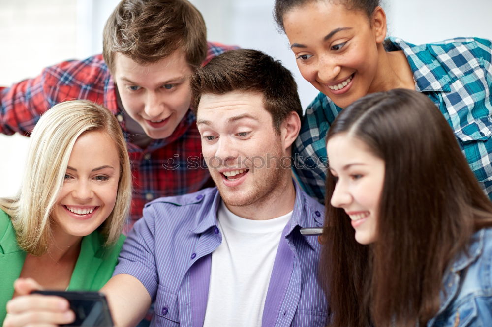 Similar – Multiracial group looking at a tablet computer outdoors