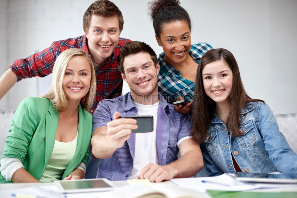 Similar – Multiracial group looking at a tablet computer outdoors