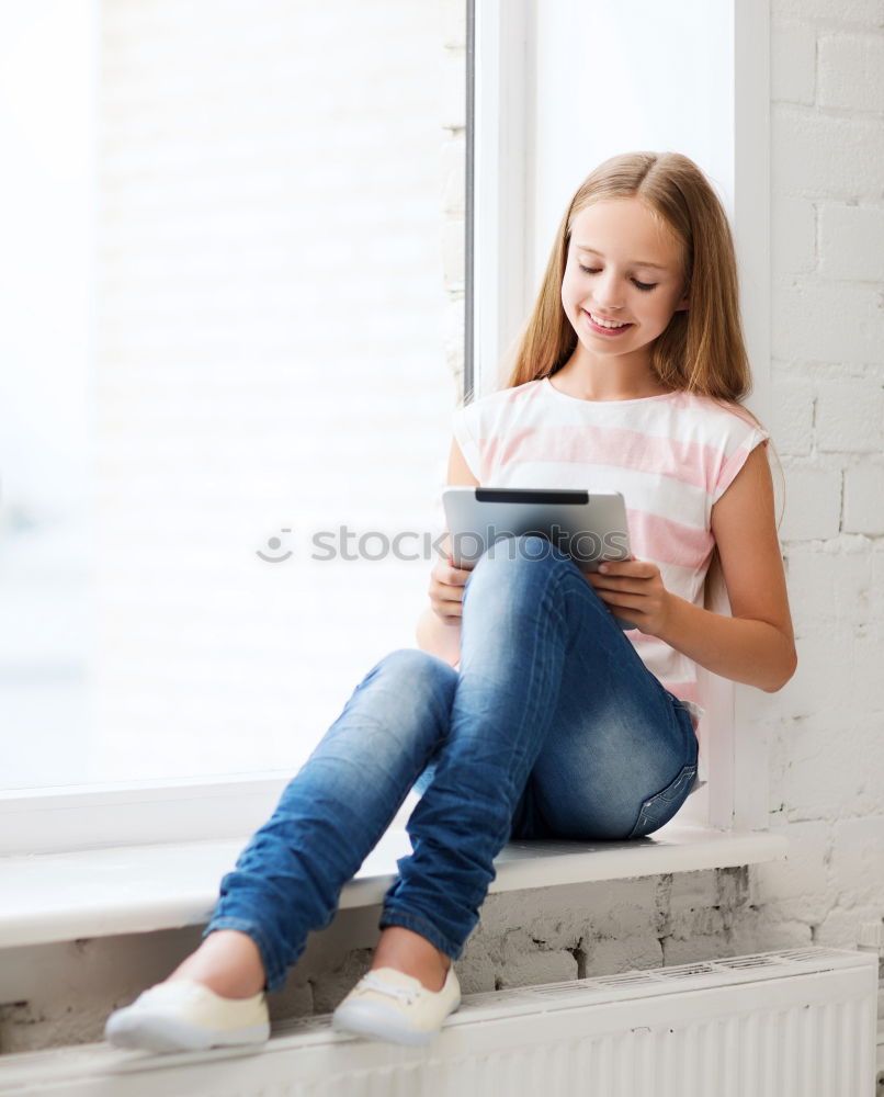 Similar – Little girl using a tablet at home