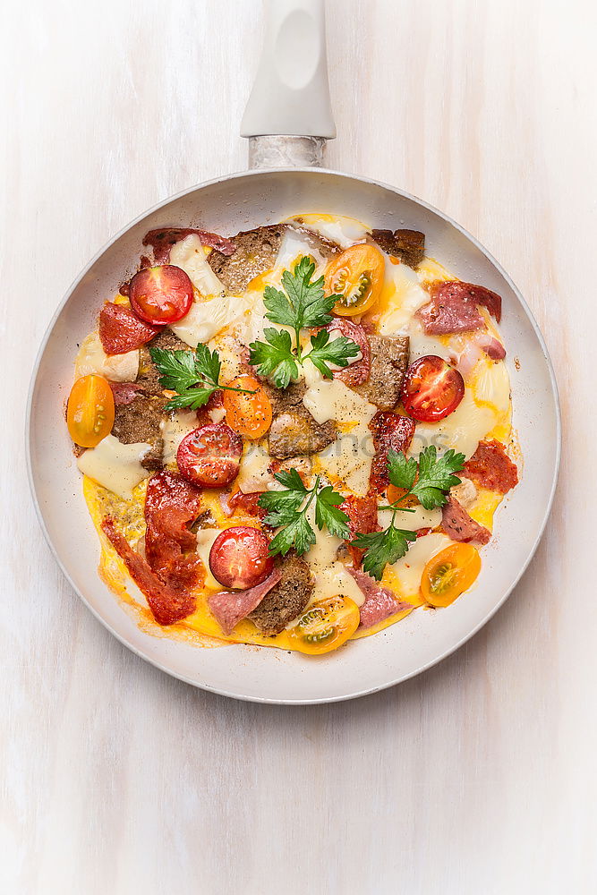 Omelette with sausage, tomatoes, bread and cheese