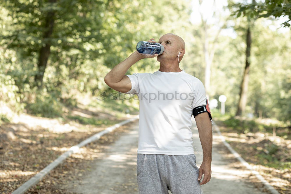 Similar – Young black man drinking water before running outdoors