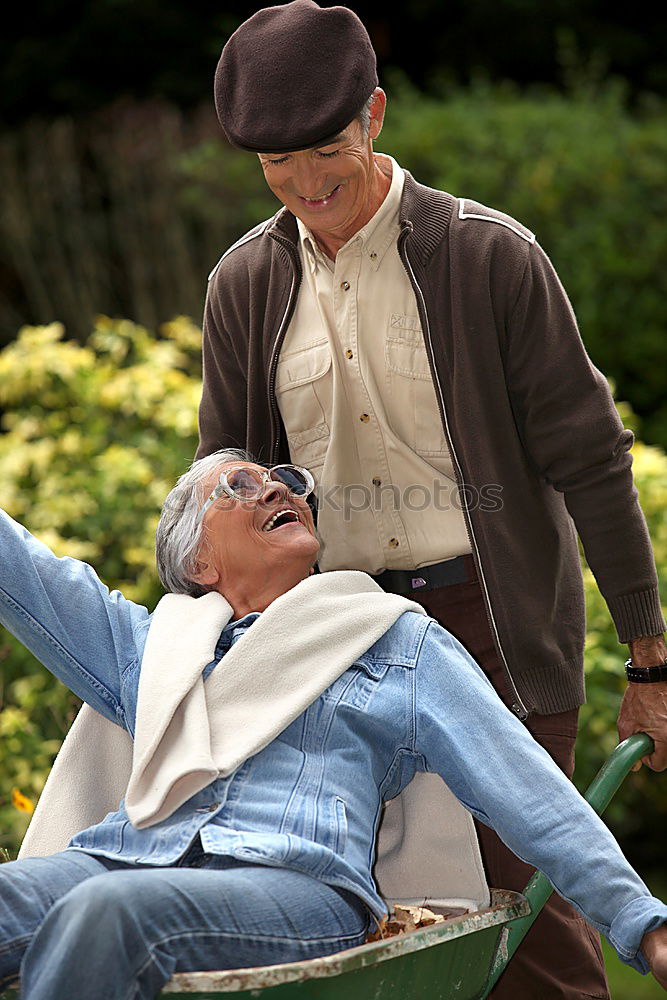 Similar – Image, Stock Photo Portrait of two laughing seniors, one with silver-grey curls and glasses, the other with cap in front of an old wall