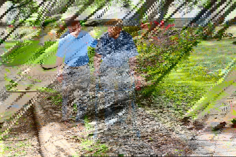 Similar – Image, Stock Photo Cheerful young man teaching his son to play mini golf