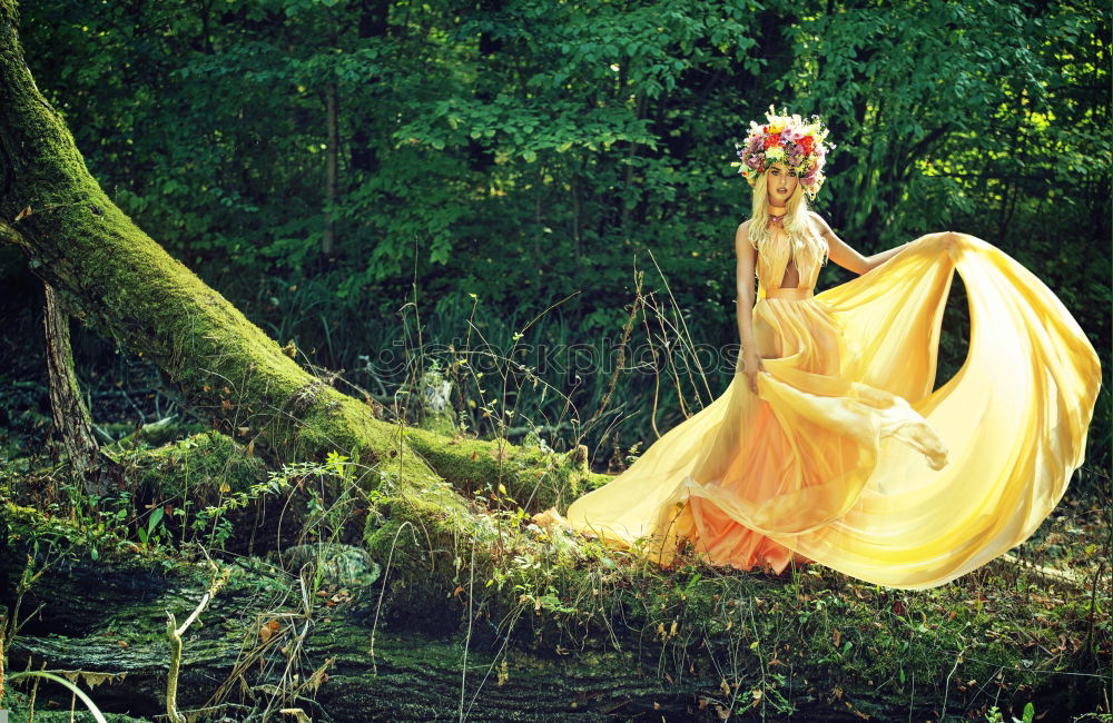 Similar – Young tall woman sitting barefoot by tree in forest in purple wedding dress