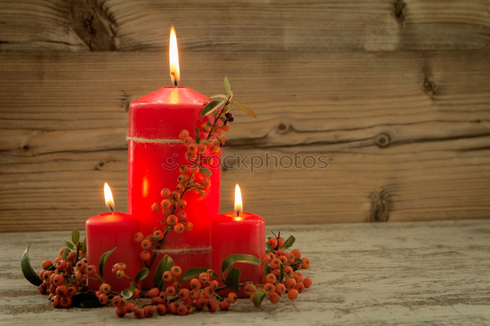 Similar – Lighted candles with red colored pearls around