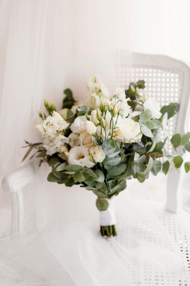 Similar – Low angle view of a pretty wedding bouquet of white flowers lying on a table top with selective focus and copyspace