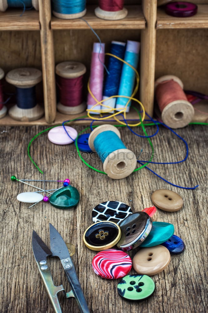 Similar – Image, Stock Photo Threaded in red: Sewing equipment, such as needle, thread, thimble wool, crochet hook and a needle cushion on a wooden table