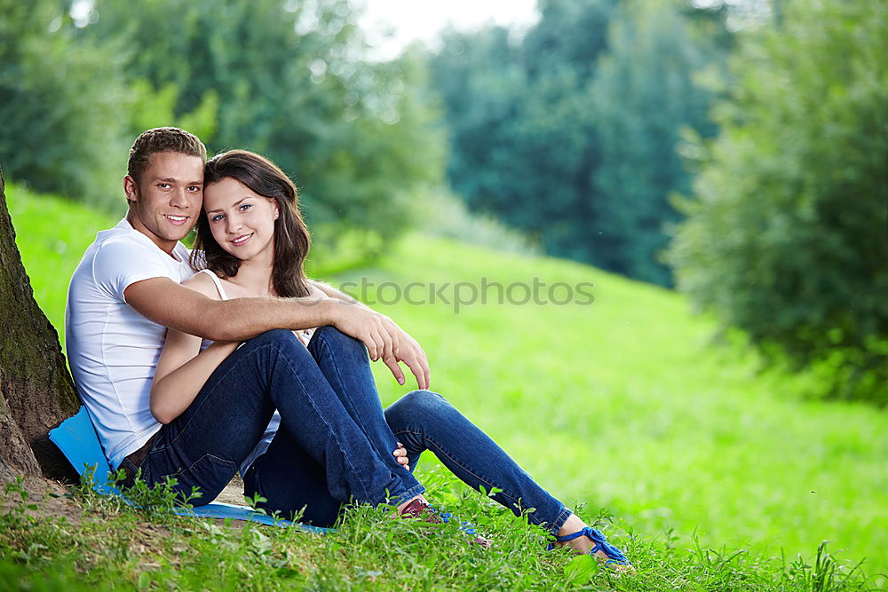 Similar – Happy smiling couple laying on green grass