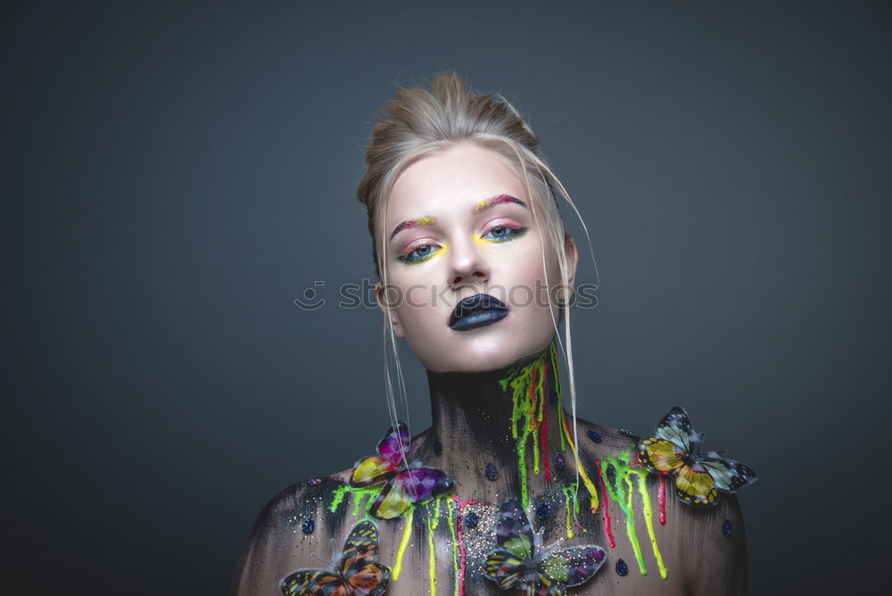 Young girl with creative makeup with butterflies