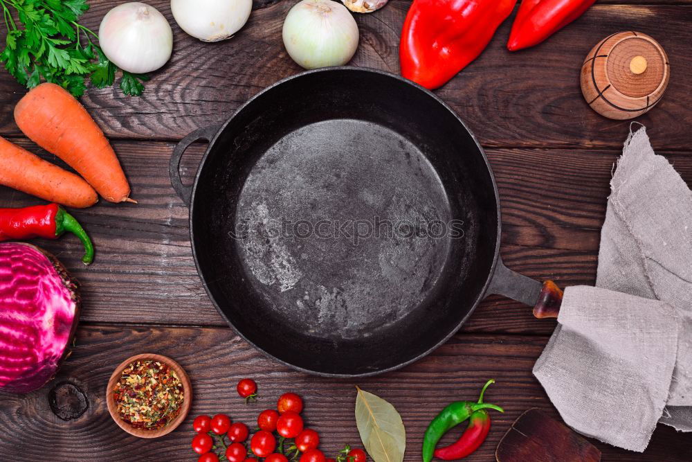 Black frying pan and fresh vegetables