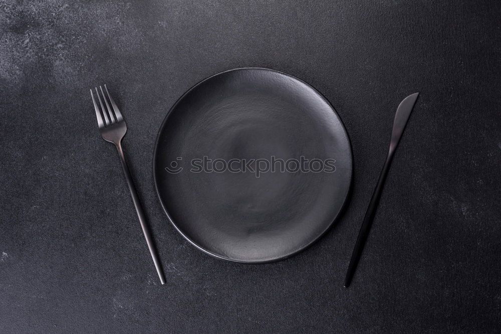 Similar – Fish dish: a plate and a fork with a tiny fish on top