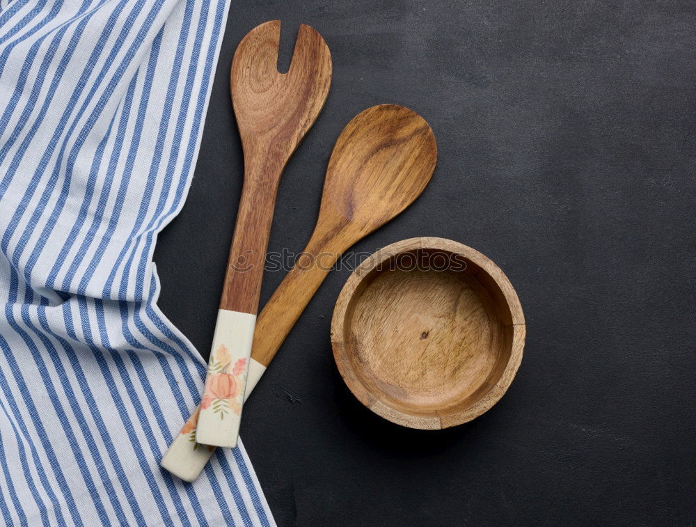 Similar – Black cast-iron frying pan with a wooden spatula