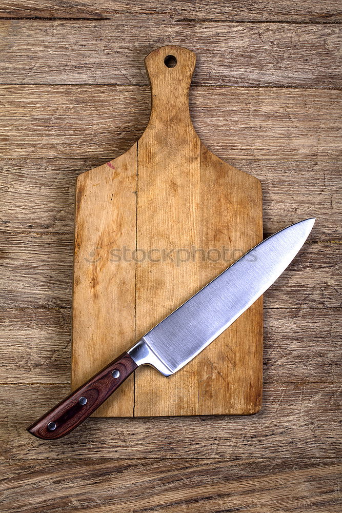 Similar – Old hatchet an a wooden cutting board, top view