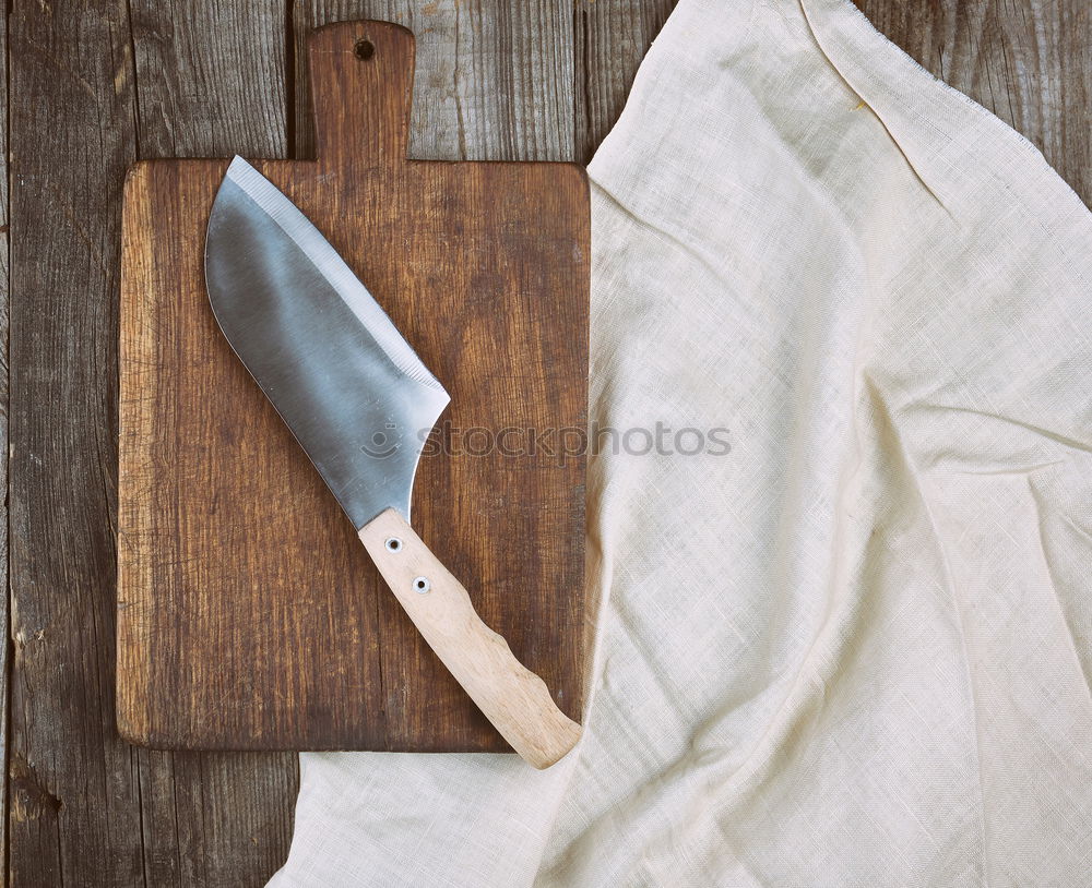 Similar – Old hatchet an a wooden cutting board, top view