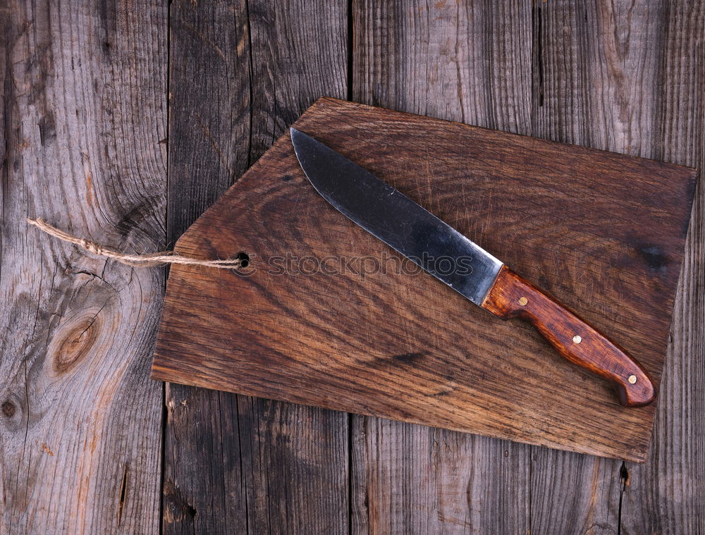 empty old brown wooden cutting board and knife