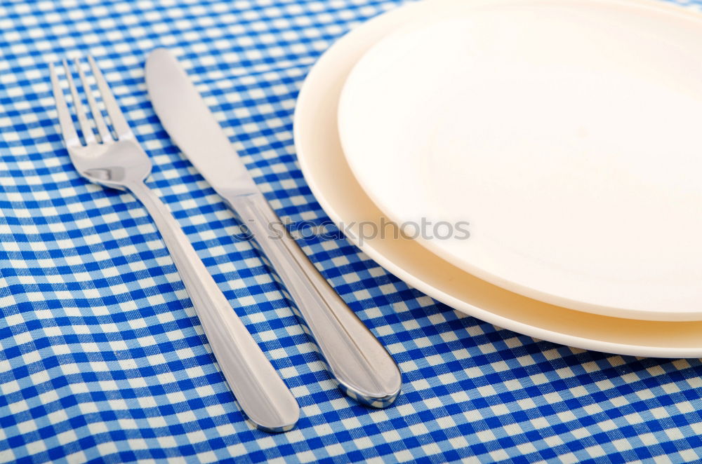 Similar – Crossed knife and fork on an empty white plate