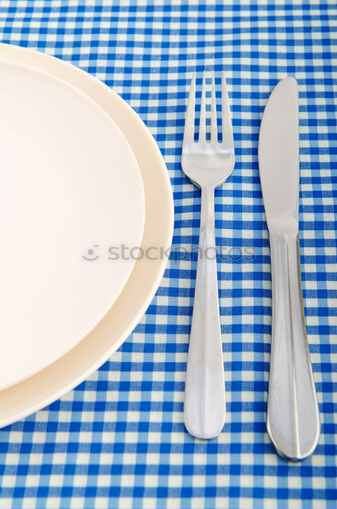 Similar – Disposable plastic cutlery on blue background. Top view