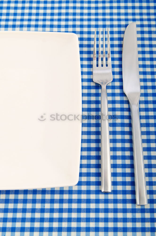 Similar – Disposable plastic cutlery on blue background. Top view