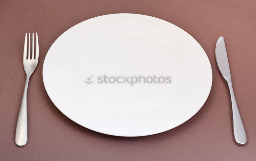 Similar – White empty plate and metal vintage knife and fork