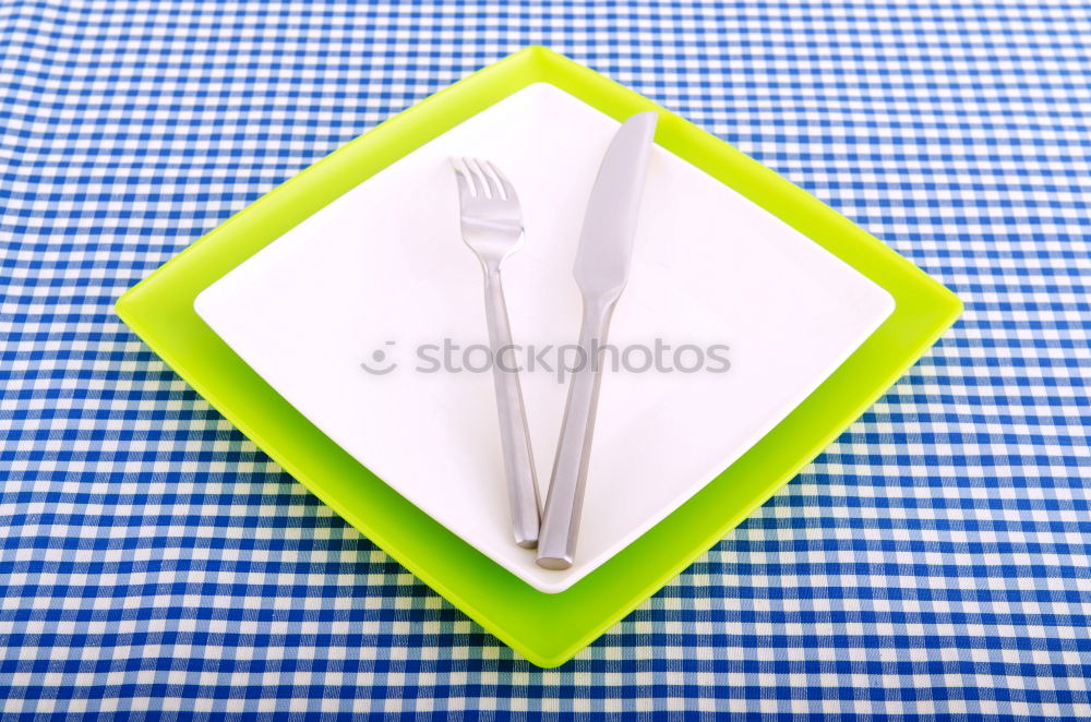 Similar – Image, Stock Photo To the point! A plate with a blue rim, on it many green and a blue ball, dots and a fork on a wooden table