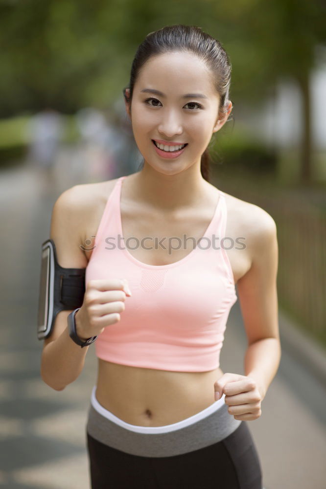 Similar – Woman jogging along a country road while listening to music