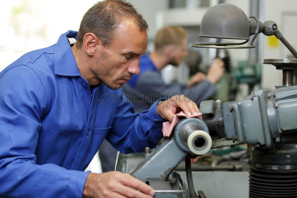 Similar – Professional Mechanic Repairing Car.