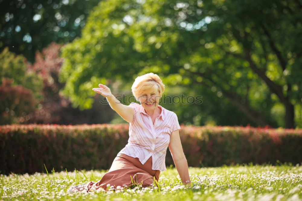 Similar – Happy little girl is smiling and  swinging  in the garden in a sunny summer day.