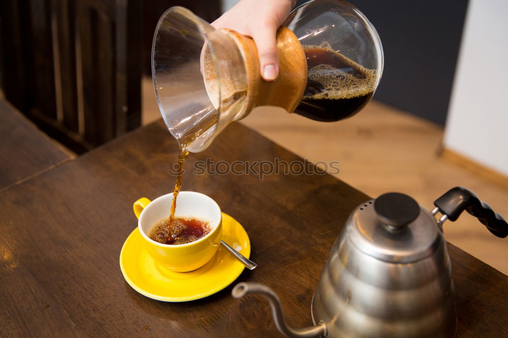 Similar – Glass coffeepot, white porcelain filter, light brown filter paper and dark brown continuous bubble forming coffee, apple, egg in wooden egg cup, white cup, corn waffles, white table in front of grey wall in the morning light.