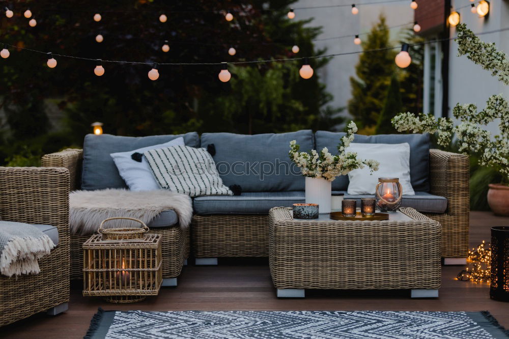 Similar – Stilvolle Gartenmöbel im Freien, Sofa mit Kissen und Lampen, hängende Glühbirnen, gemütliche moderne Ecke auf der Terrasse