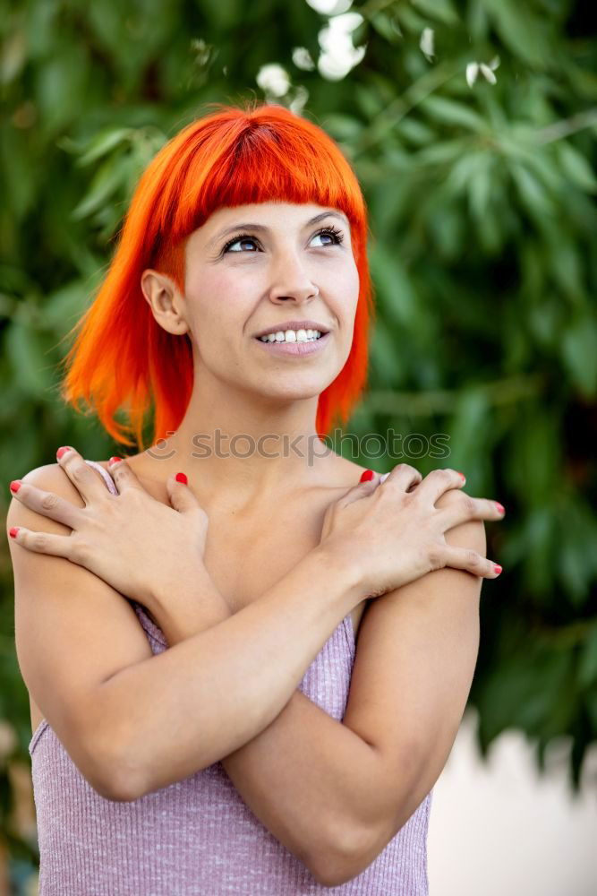 Similar – Redhead woman smelling a flower in a park