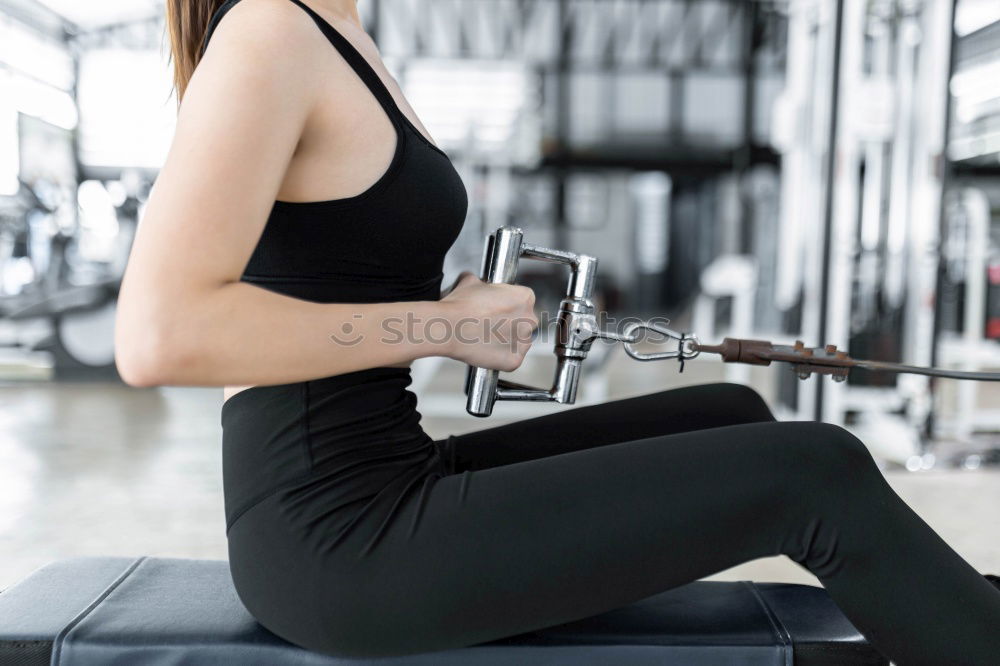 Young fit woman at the gym doing abs workout