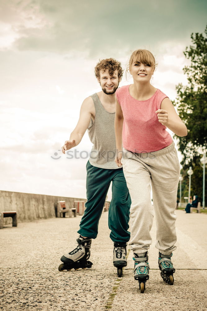 Two kids riding together wtih a skate board