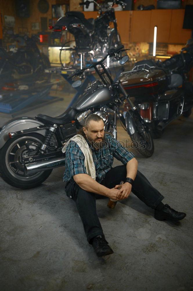 Similar – Image, Stock Photo Biker taking motorbike to the garage