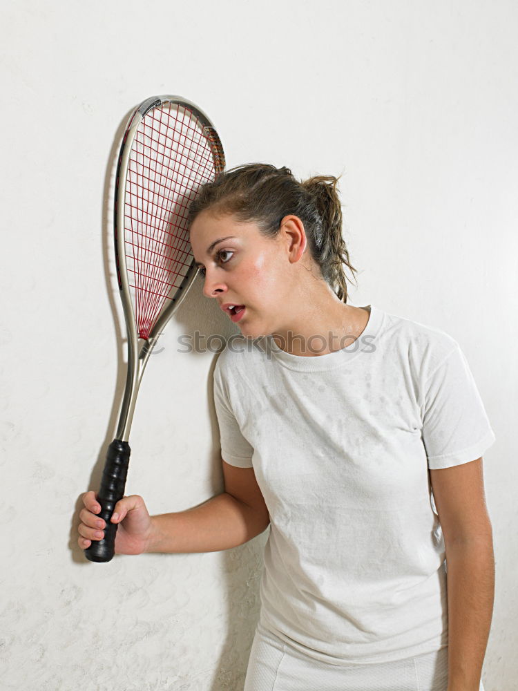 Similar – Face of a young woman hiding behind a featherball bat. Repeating the colour red. Sports grouch. Unsportsmanlike. Defense