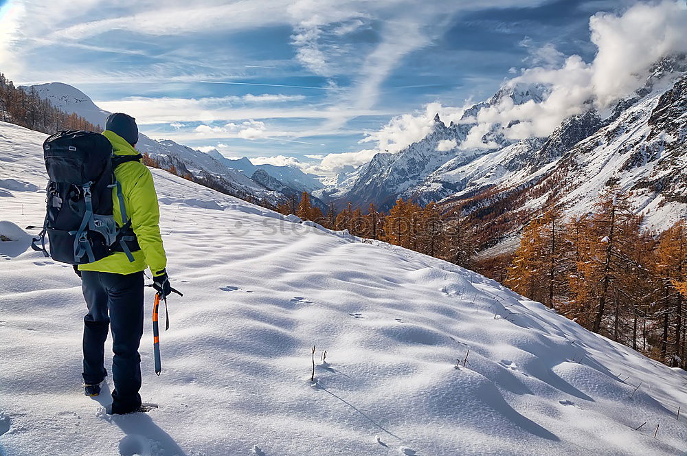 Similar – Image, Stock Photo Snowboarder goes downhill over a snowy mountain landscape.