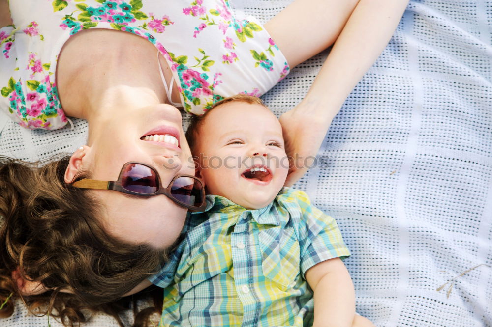 Similar – happy young mother and her baby boy lying on bed and smiling