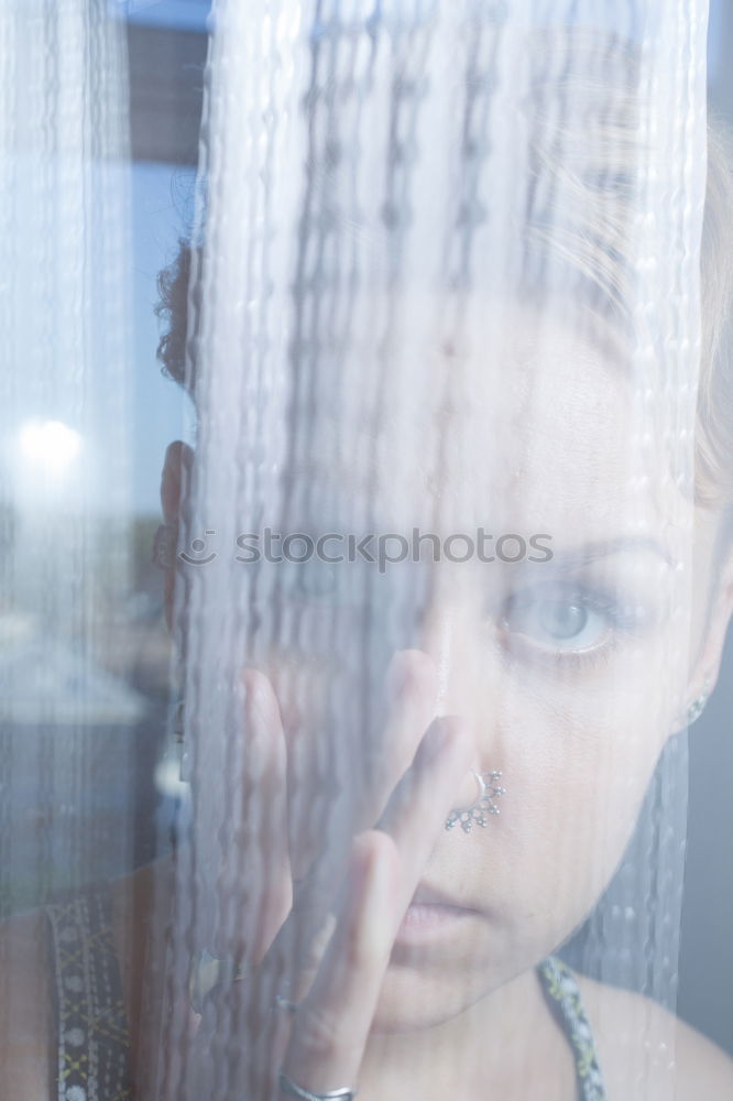 Similar – Dreaming girl looking away in window