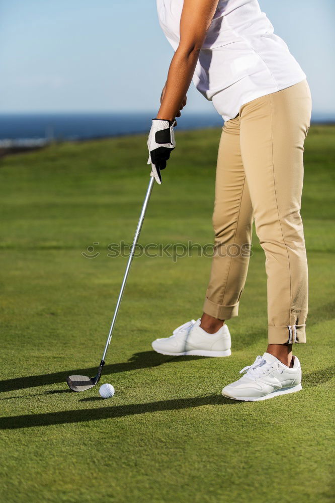 Similar – Female golfer practicing on a driving range