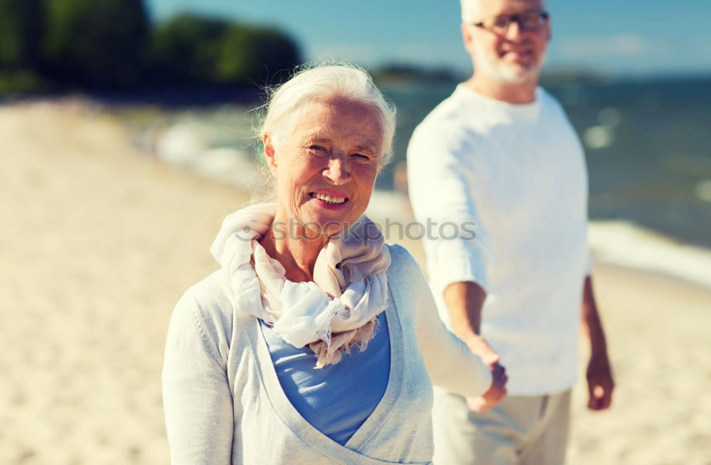 Similar – Senior man and woman having a run along the shore. Scene with sea, sand and trees. Healthy and active way of life