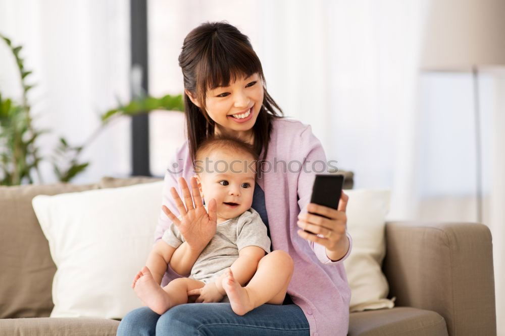 Similar – happy mother and toddler son using tablet