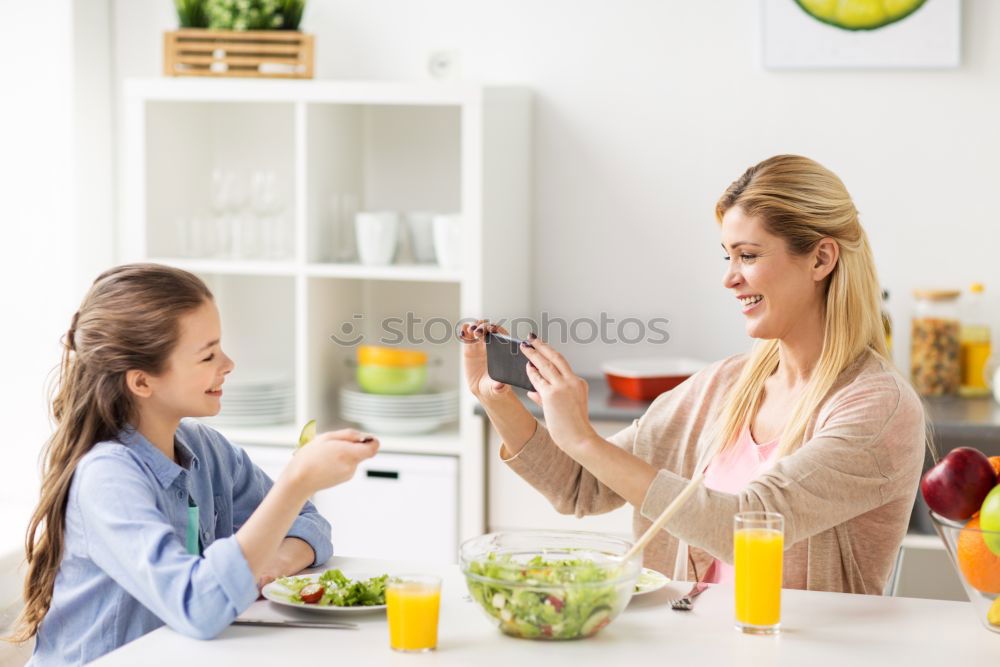 Similar – Image, Stock Photo Little girl cooking with her mother in the kitchen.