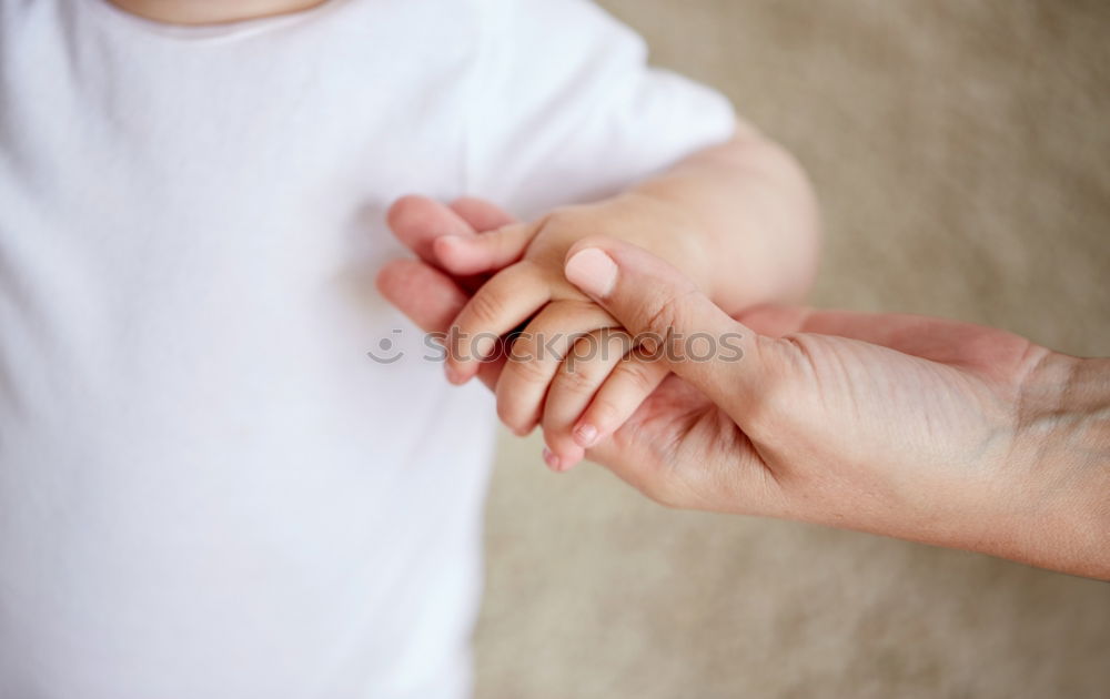 Similar – Baby girl sitting over legs of senior man outdoors