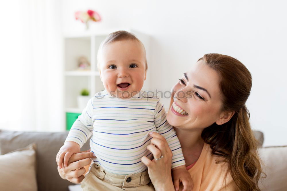 Similar – happy young mother and her baby boy lying on bed and smiling