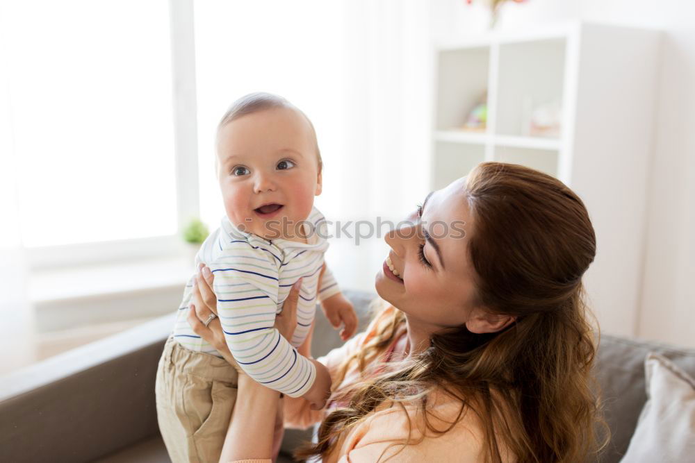 Similar – happy young mother and her baby boy lying on bed and smiling