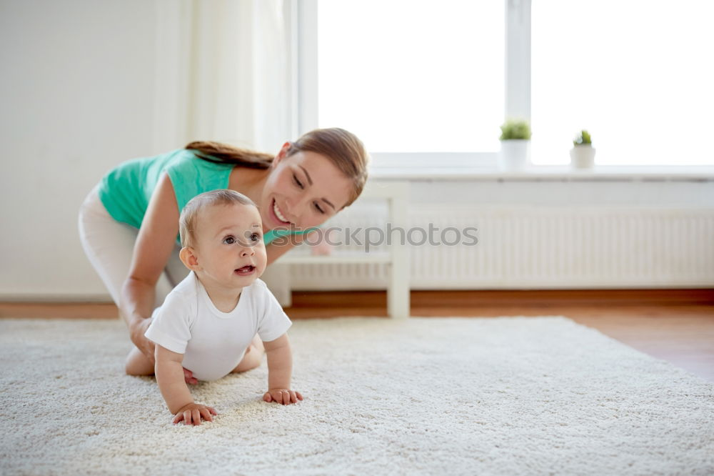 Similar – Image, Stock Photo A baby girl studies something on haunches, while her older brother watches her from upstairs sitting on the steps